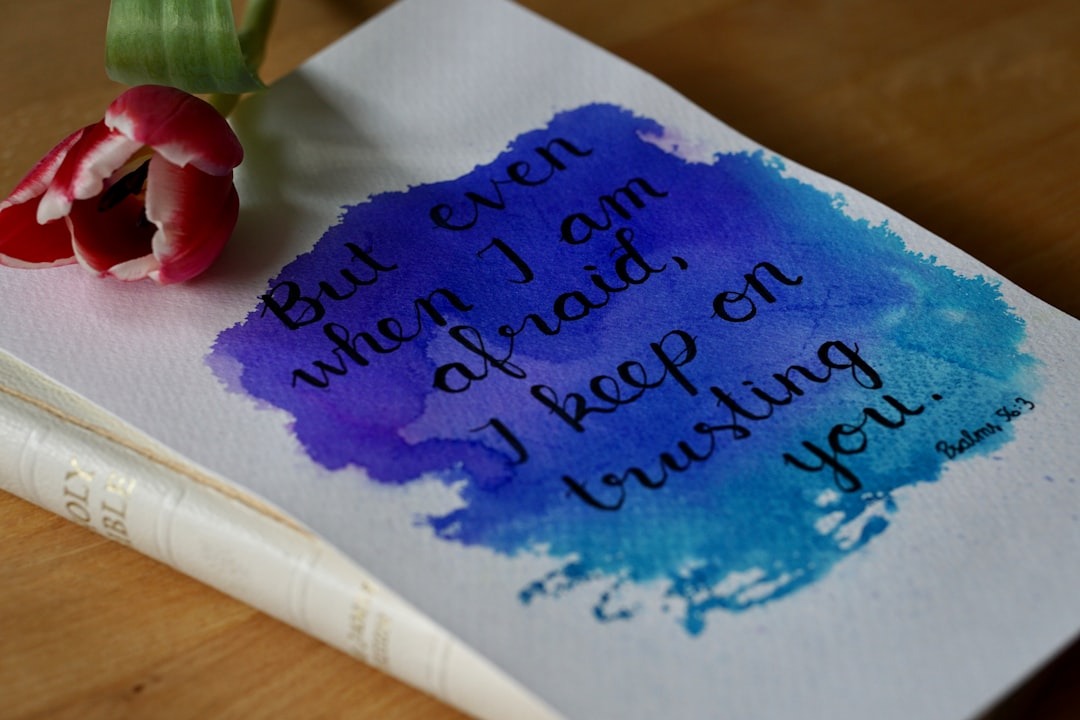 A tulip and Bible sit beside a handwritten spiritual quote.